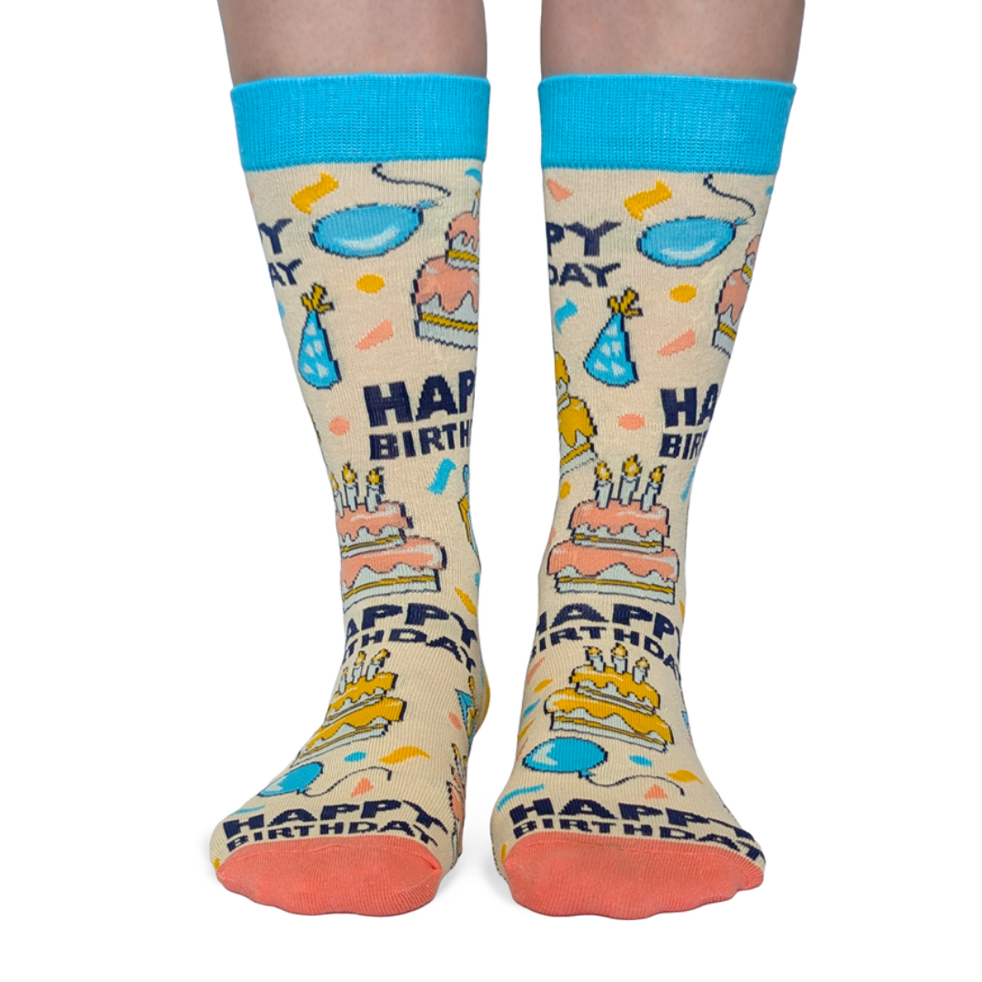 Birthday-themed socks with colorful graphics on a white background