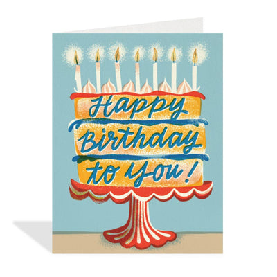Birthday card with a cake illustration and 'Happy Birthday to you!' text on a blue background.
