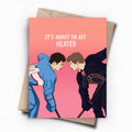 Greeting card with two hockey players facing each other and text 'It's about to get heated' on a pink background.