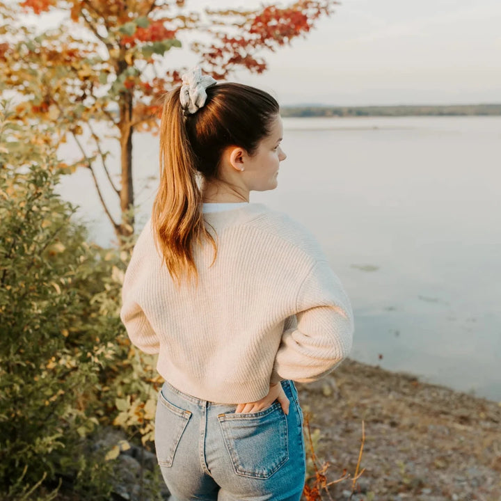 A light grey ribbed scrunchie.