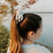 A light grey ribbed scrunchie.