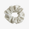 A light grey ribbed scrunchie.