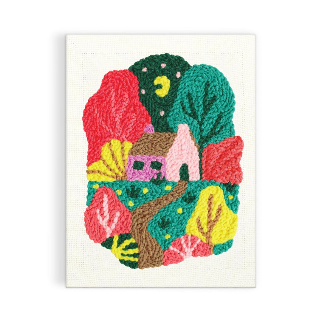 Colorful embroidered patch with a house and nature elements on a white background