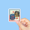 Hockey jersey sticker with names and numbers held by a hand on a blue background