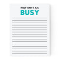Notepad with text 'HOLY SHIT I AM BUSY' in black and teal on a white background