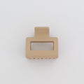 Beige hair clip on a light gray background