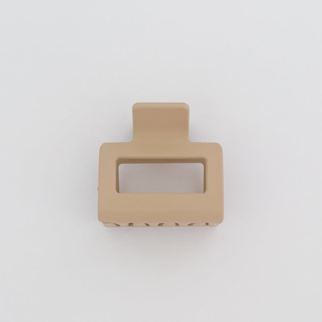 Beige hair clip on a light gray background