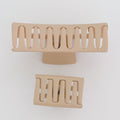 Two beige hair clips on a white background