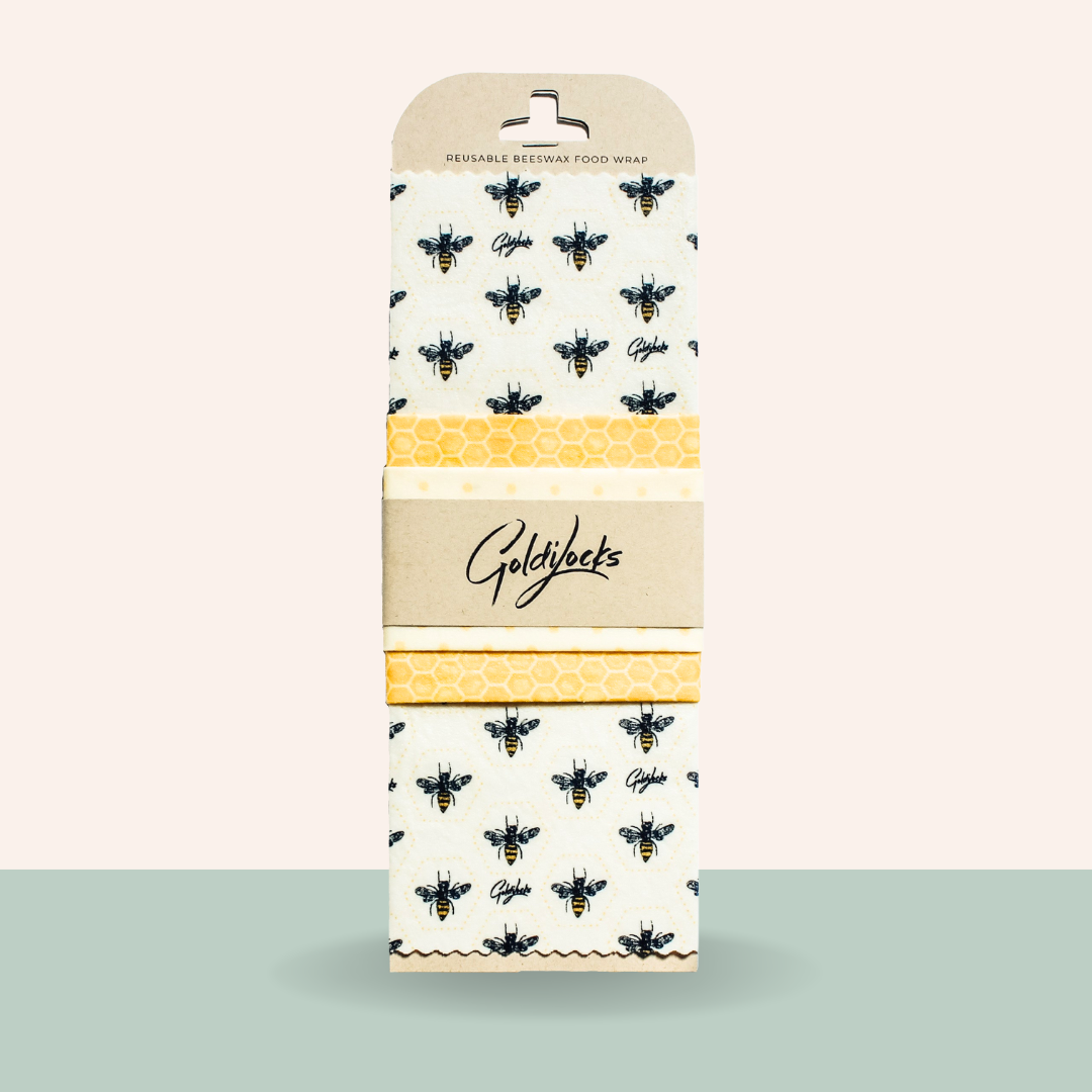 Goldkant reusable bee-wax food wrap with bee and honeycomb pattern on a beige background
