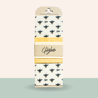 Goldkant reusable bee-wax food wrap with bee and honeycomb pattern on a beige background