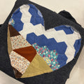 Patchwork quilt with geometric patterns on a plain background
