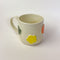 Flower Mug, a white ceramic mug with 3 dimensional flowers in a rainbow of colours.