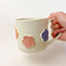 Flower Mug, a white ceramic mug with 3 dimensional flowers in a rainbow of colours.