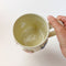 Flower Mug, a white ceramic mug with 3 dimensional flowers in a rainbow of colours.