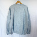 The back view of the same grey Gildan crewneck sweatshirt, hanging on a wooden hanger against a white background. The back is plain.
