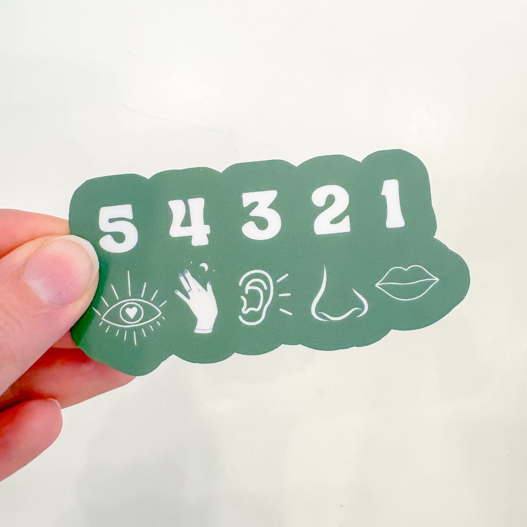Green sticker with numbers 54321 held by a hand on a white background
