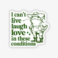 Sticker with a frog wearing a hat and text 'I can't live laugh love in these conditions' on a white background