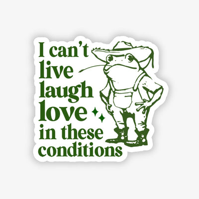 Sticker with a frog wearing a hat and text 'I can't live laugh love in these conditions' on a white background