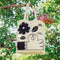 A white tote bag with a black and white illustration. The illustration shows a hand picking a flower. The text 