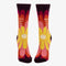 A pair of women's crew socks with a dark purple background and a vibrant, large floral pattern in shades of red, fuchsia, pink, and yellow. Text on one sock reads 