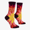 A pair of women's crew socks with a dark purple background and a vibrant, large floral pattern in shades of red, fuchsia, pink, and yellow. Text on one sock reads 