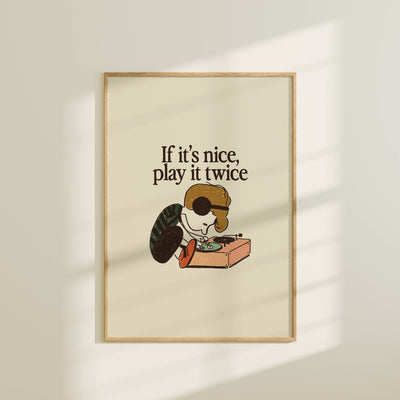 Framed poster with a cartoon character and text 'If it's nice, play it twice' on a beige background.