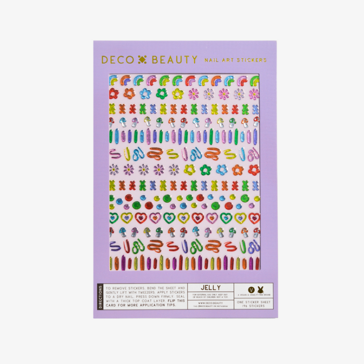 A sheet of colorful nail art stickers with various shapes like rainbows, mushrooms, flowers, and hearts. The sheet is purple and has the brand name 