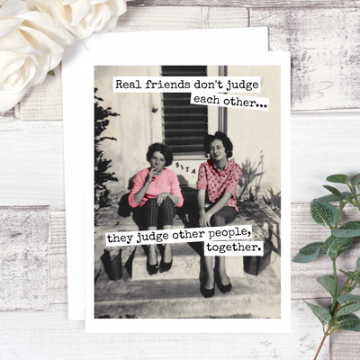 A greeting card featuring a vintage black and white photo of two women sitting on steps, one smoking. Text on the card reads: 