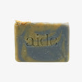 Bar of soap with 'aide' branding on a white background