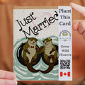 Card with otters holding hands and text 'Just Married' with a QR code and Canadian flag on the right.