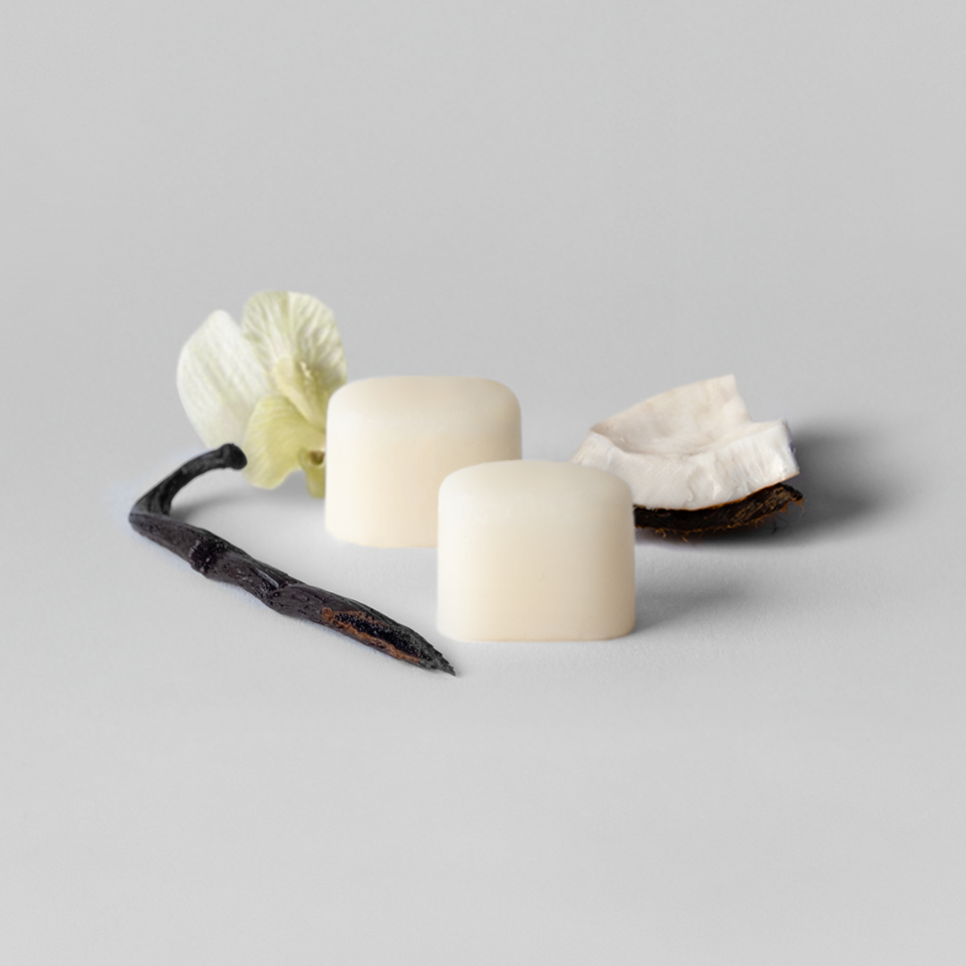 Three white candles with decorative elements on a light gray background