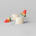 Watermelon-themed earrings on a light gray background