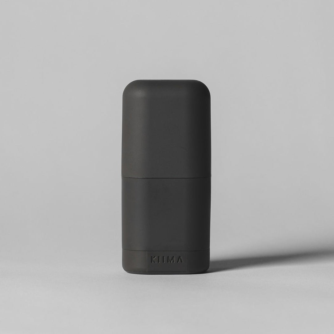 Black cylindrical container on a gray background