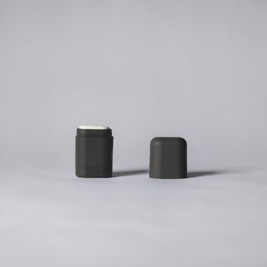 Two black cylindrical containers on a gray background