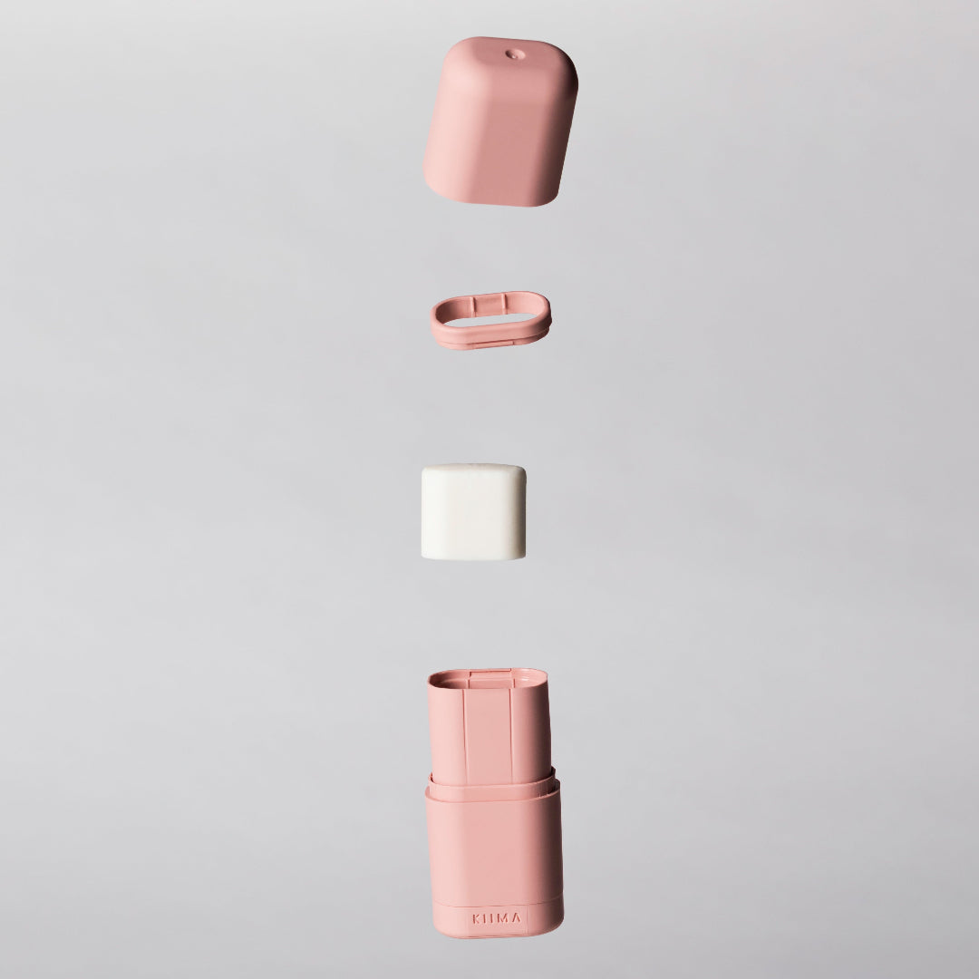 Pink ceramic container with a white lid on a gray background