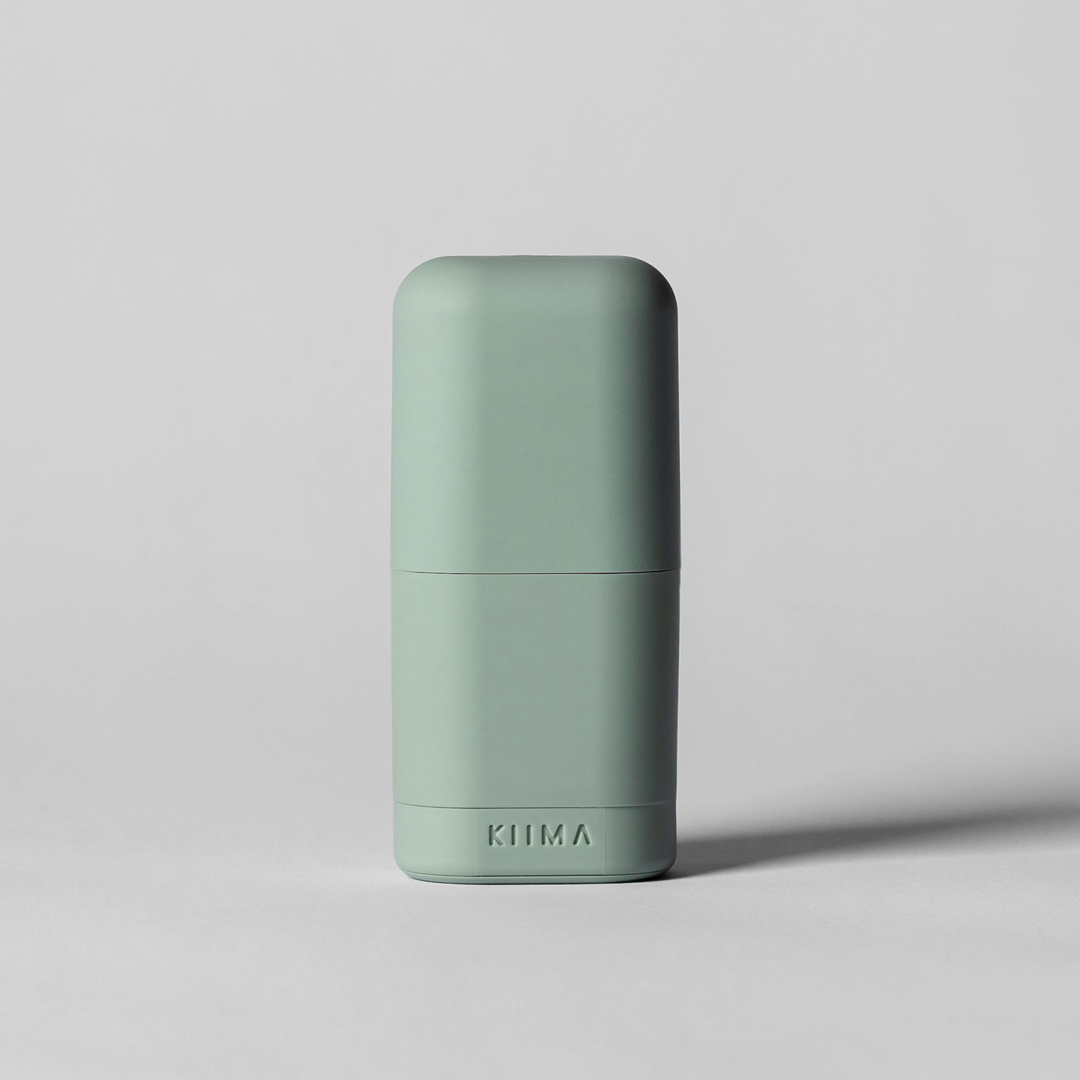 Green cylindrical container with 'Zomia' branding on a light gray background