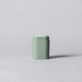 Small green container on a light gray background