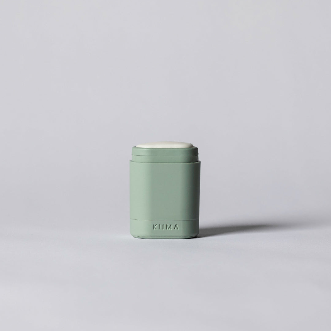 Small green container on a light gray background