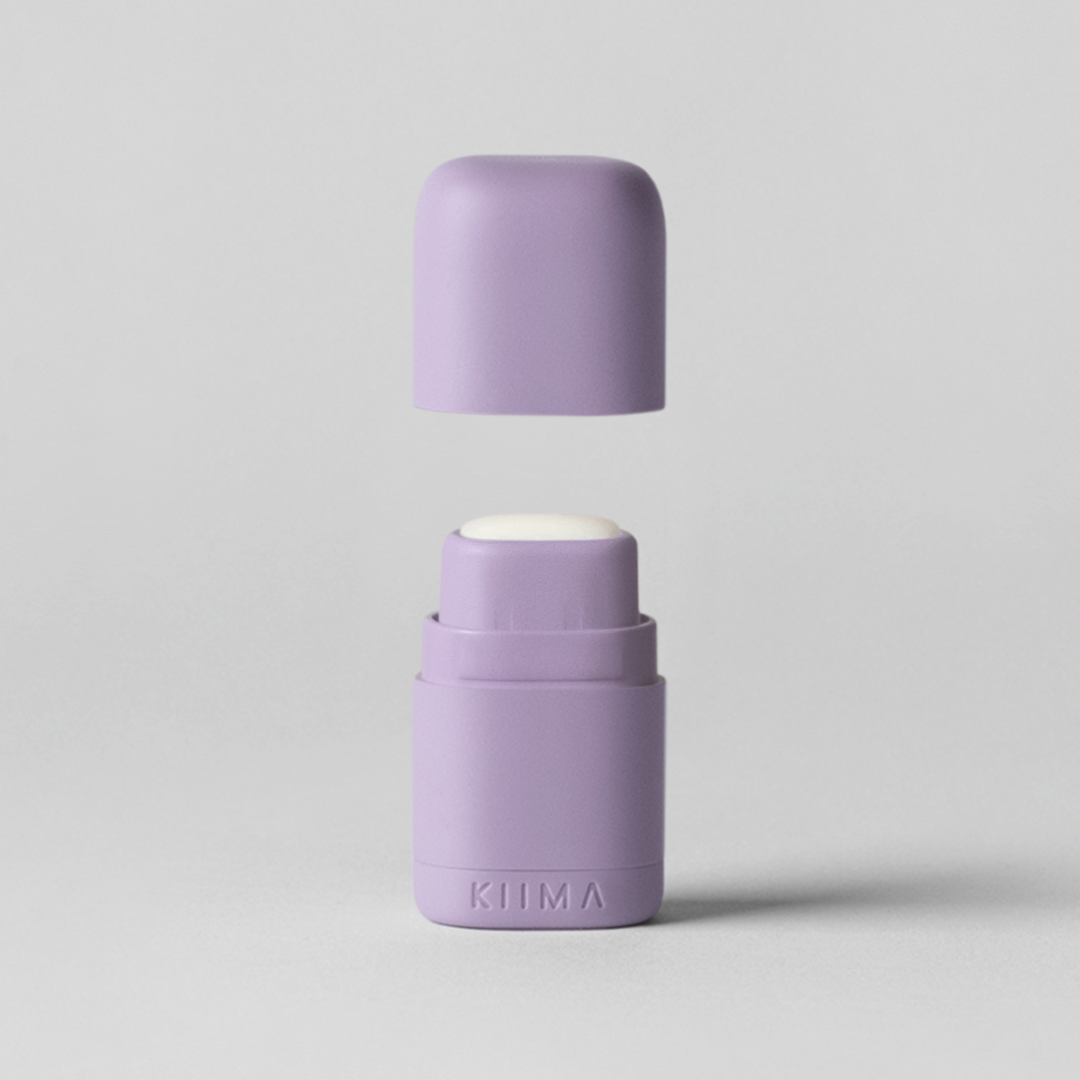 Two purple roller bottles on a light gray background