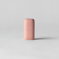 Pink cylindrical object on a light gray background