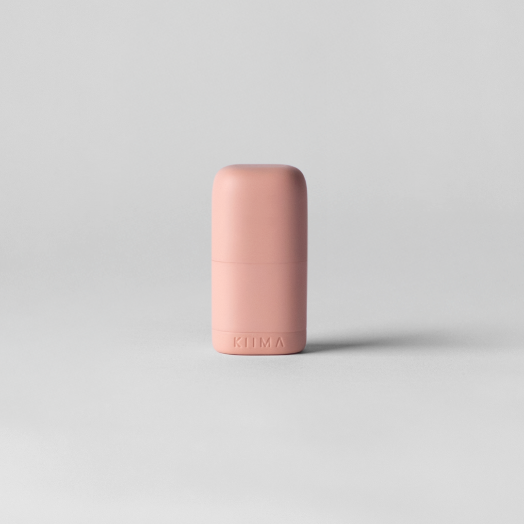 Pink cylindrical object on a light gray background