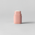 Small pink bottle on a light gray background