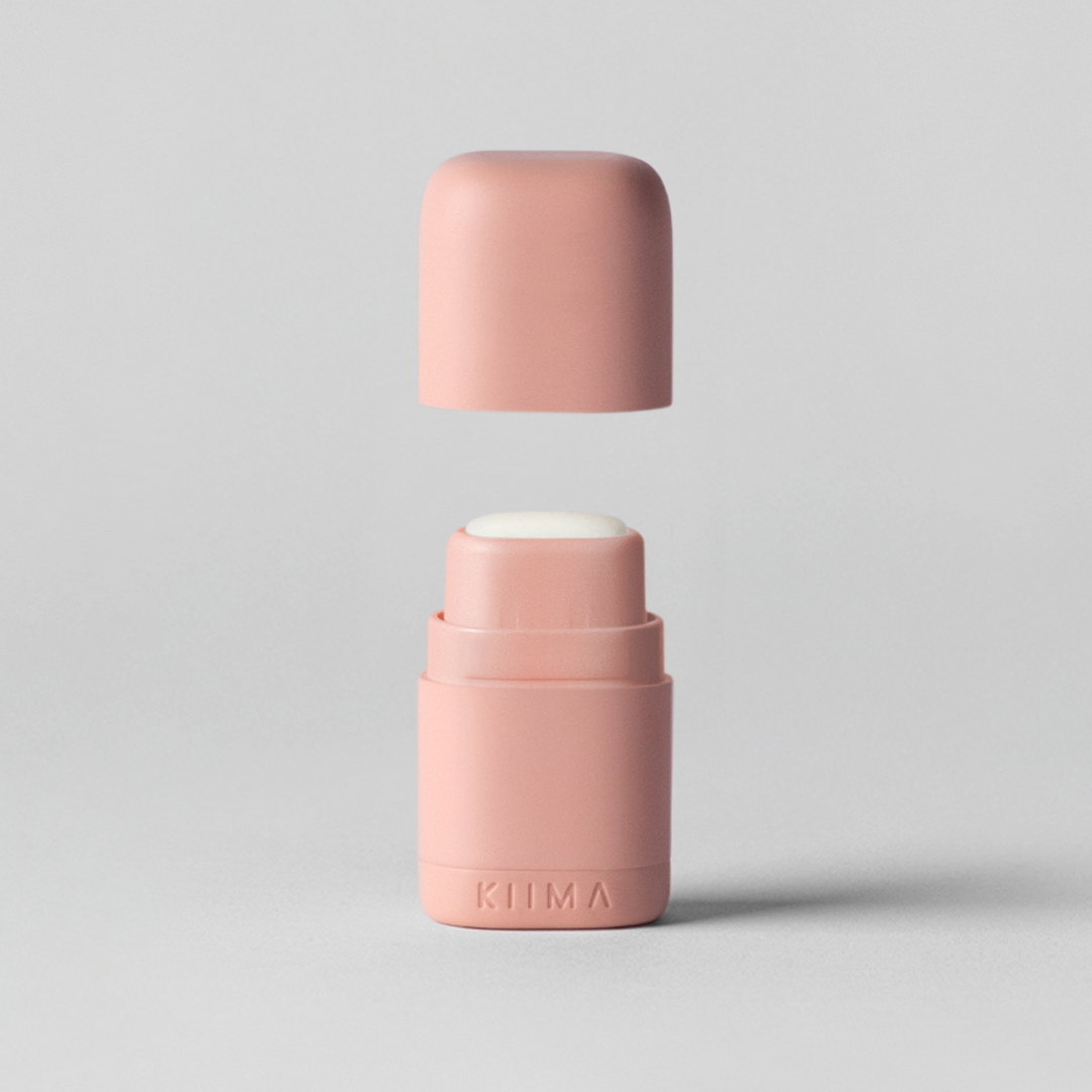 Two pink cylindrical containers on a light gray background