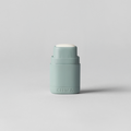 Small cylindrical container on a light gray background