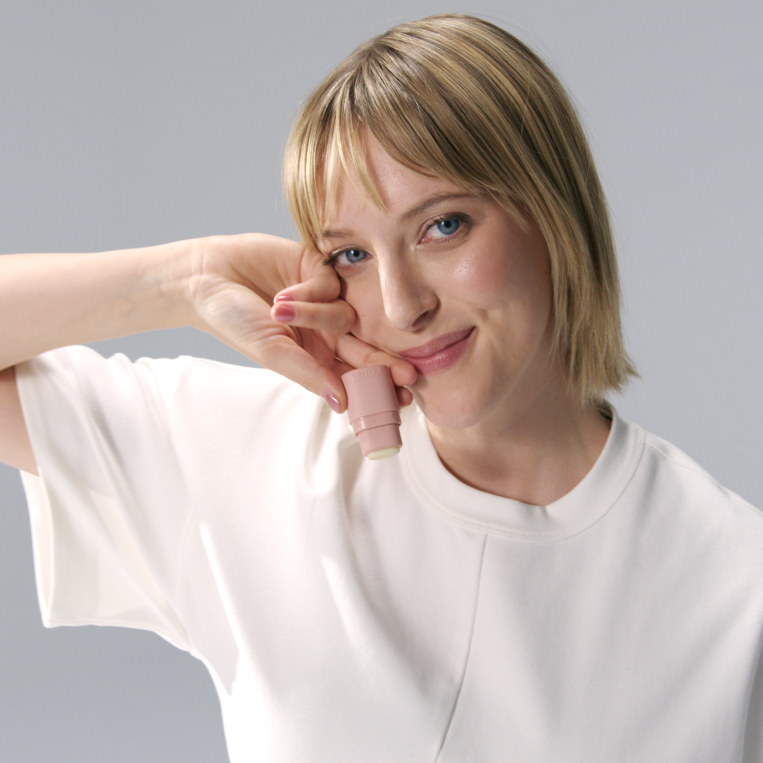 Woman wearing a white shirt against a gray background
