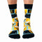 A pair of crew socks featuring a beer mug design. The socks are mostly black with yellow and blue accents. The text 
