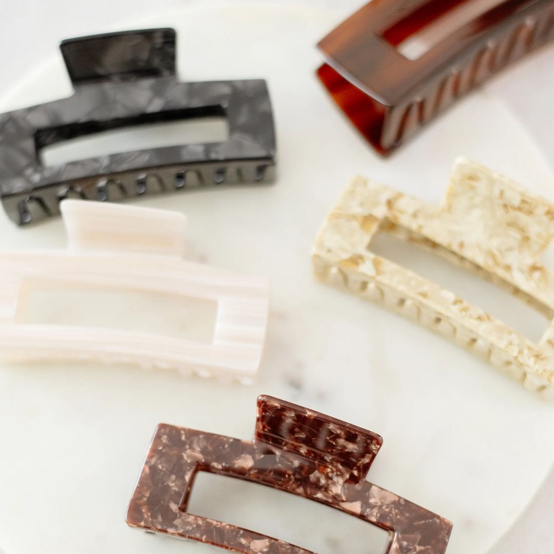 Collection of various hair clips on a white surface