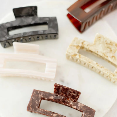 Collection of various hair clips on a white surface