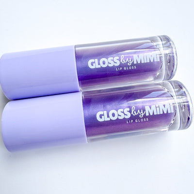 Two purple lip glosses with 'Gloss by Mimi' branding on a light background