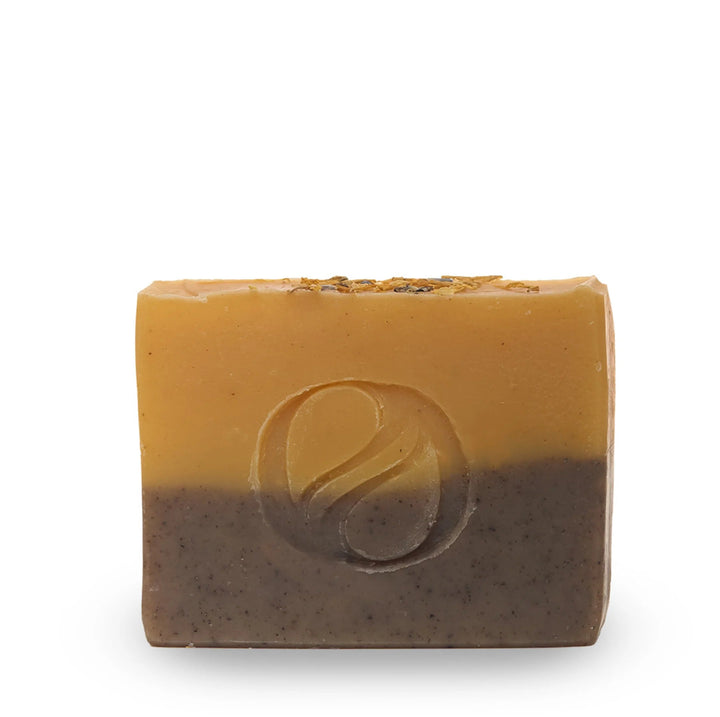 A bar of Aide Bodycare Lavender Lemongrass Soap, featuring a layered light yellow and dark brown color and a paper label with the 'aide' logo and 'Lavender Lemongrass' text, displayed on a light-colored surface with a shadow overlay. The soap is natural and handmade, available in Ottawa, Ontario, Canada.